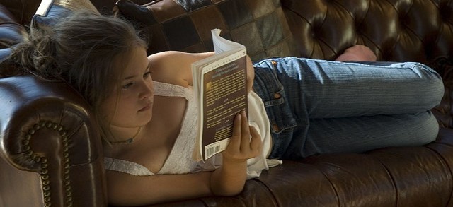 girl on leather couch reading